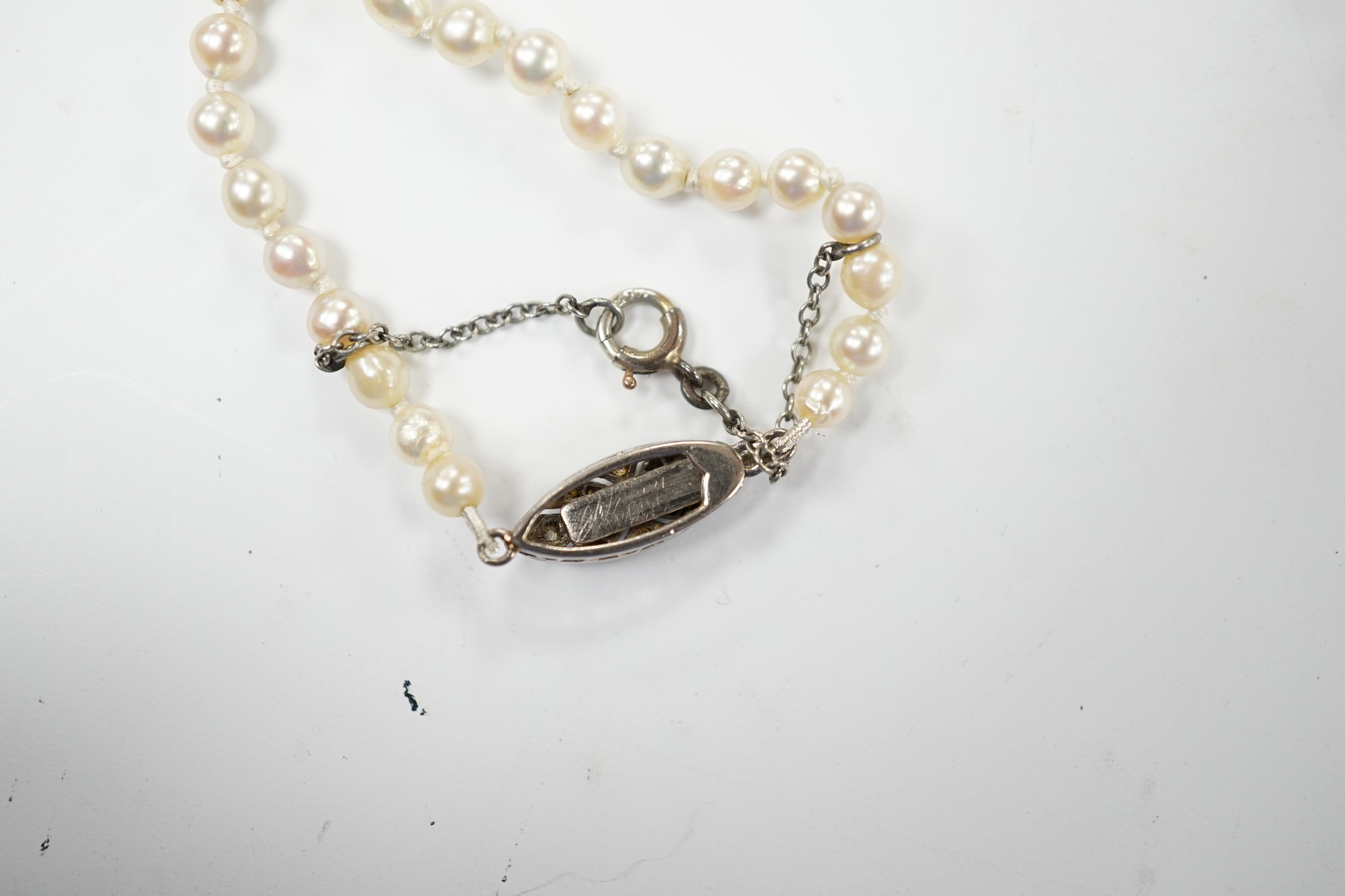 A single strand graduated cultured pearl necklace, with diamond set white metal clasp, 48cm. Good condition.